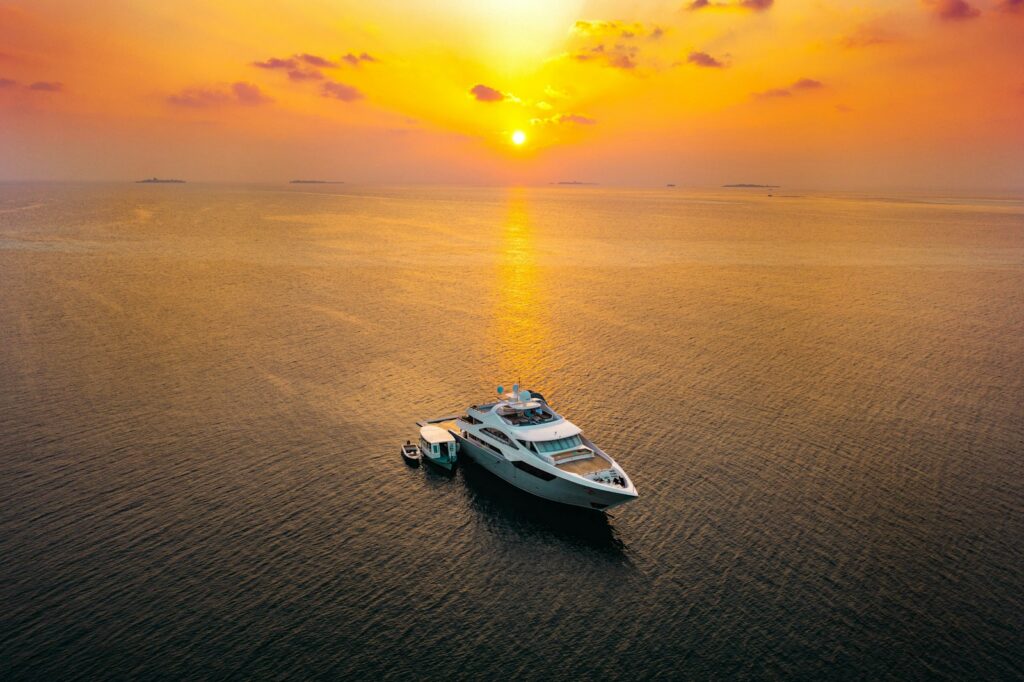 Yacht sailing Caribbean waters at sunset